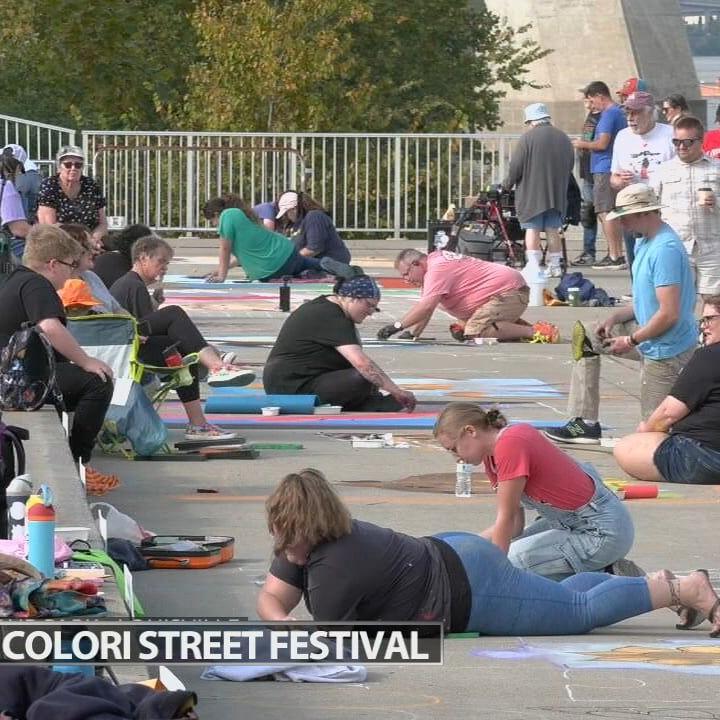 People paint sidewalks along Waterfront Park during 17th annual Via Colori Street festival